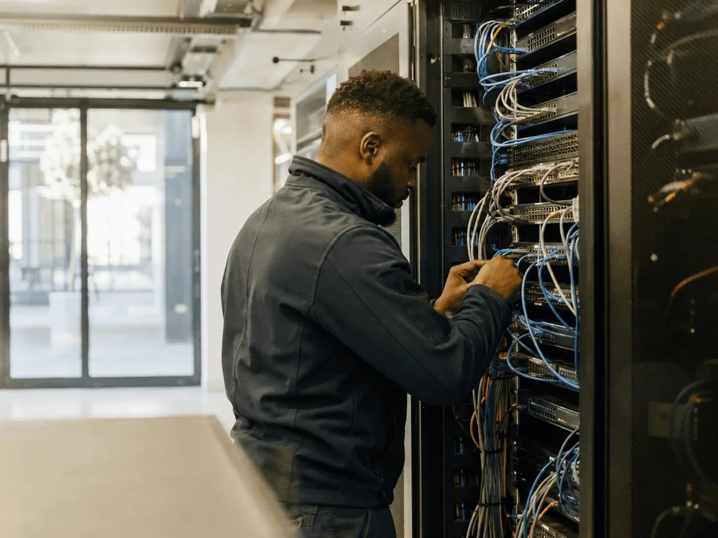 Technician working in a network cabinet